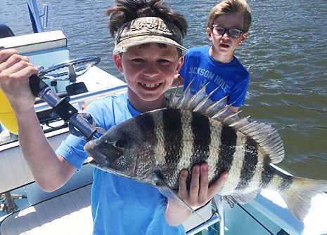 Young angler with a sheepshead aboard Drum Man Charters