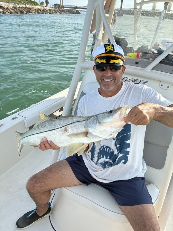 Zookeeper Charters angler holding a snook aboard the boat
